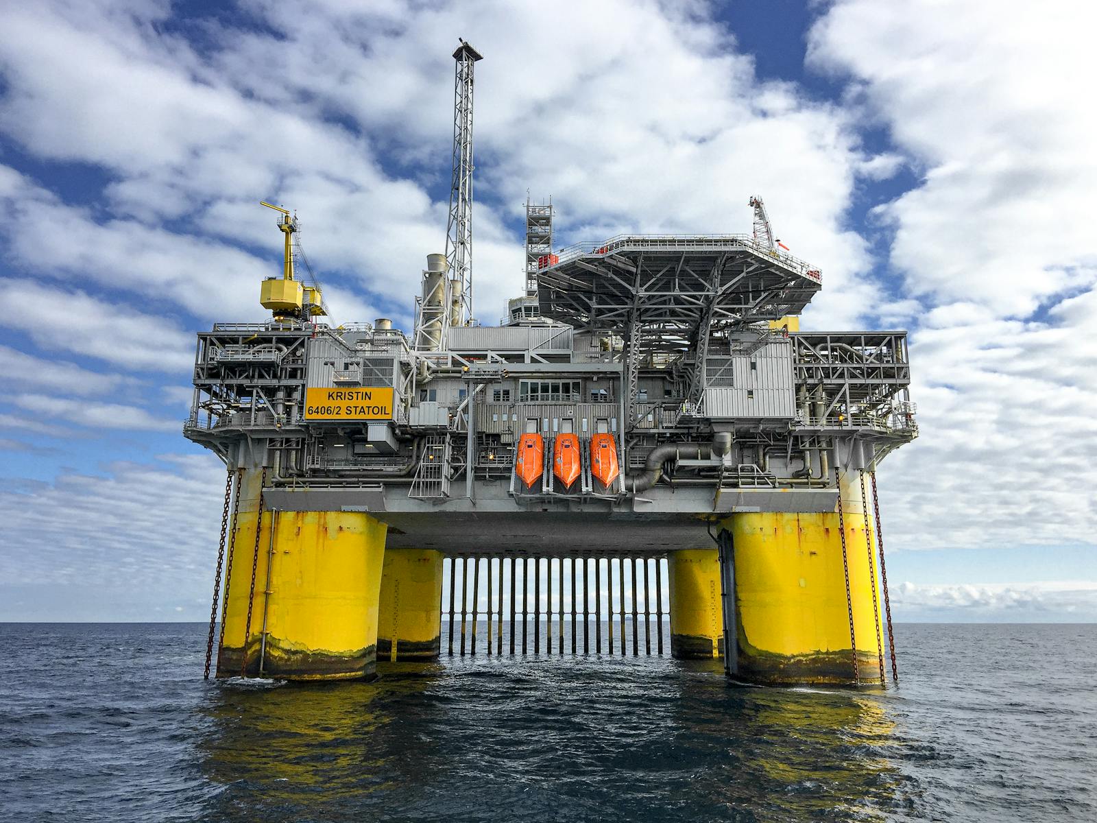 Majestic offshore oil platform in Norway's North Sea, under blue skies.